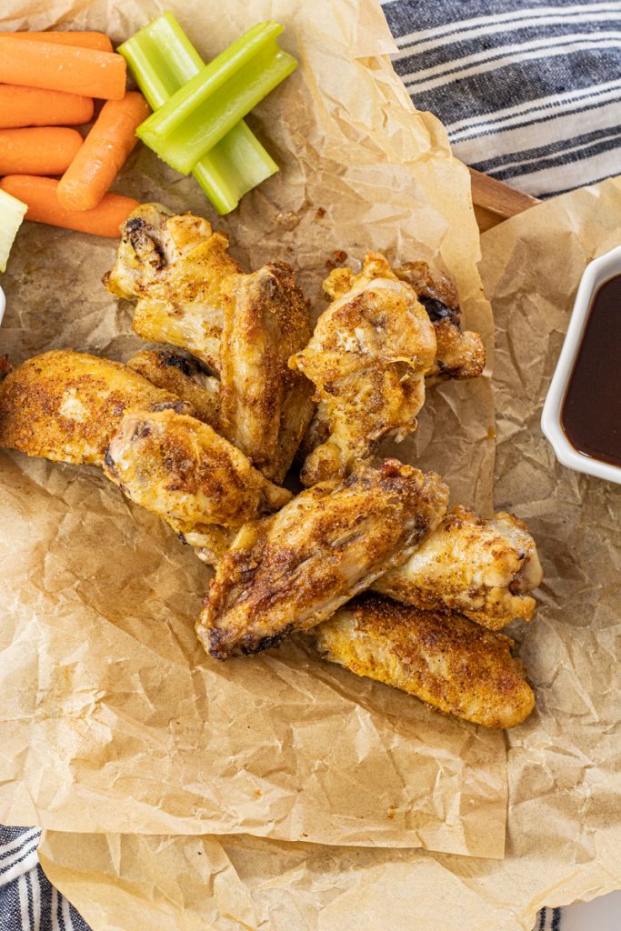 cooked chicken wings on brown parchment paper