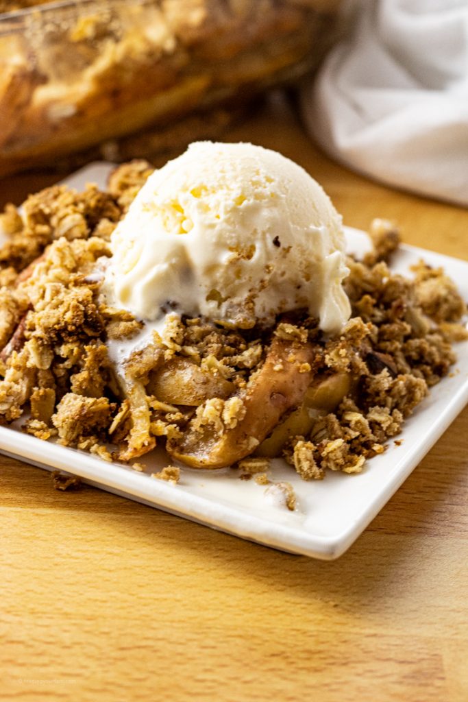 apple crisp topped with vanilla ice cream