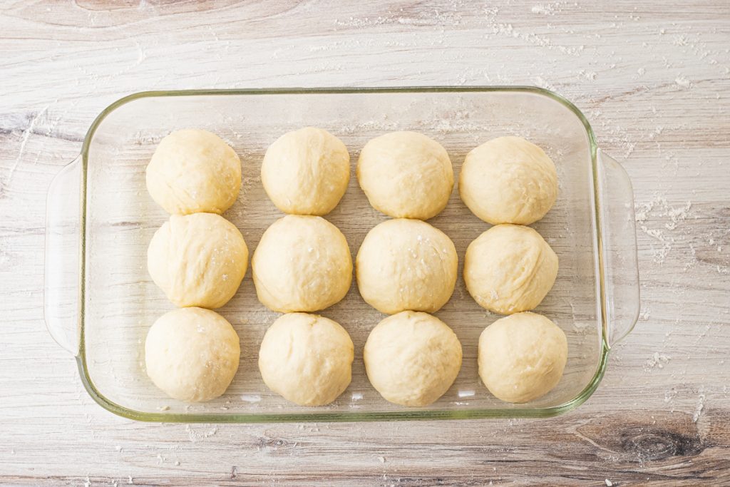 12 dough balls in a glass baking dish