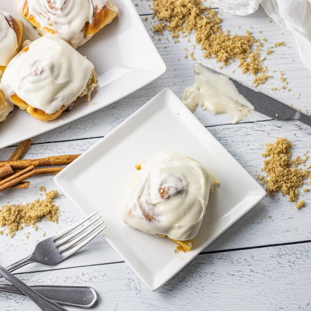 cinnamon roll on a white square plate