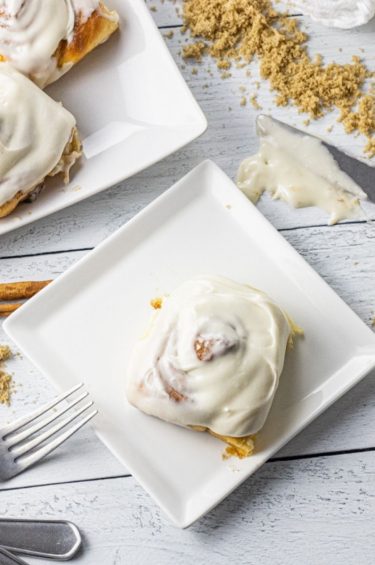cinnamon roll on a white square plate