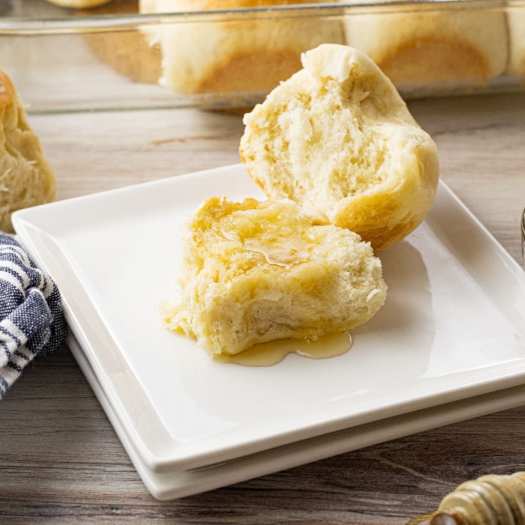 dinner roll split in half topped with honey