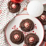 plate with chocolate cookies topped with red and white chocolate candy