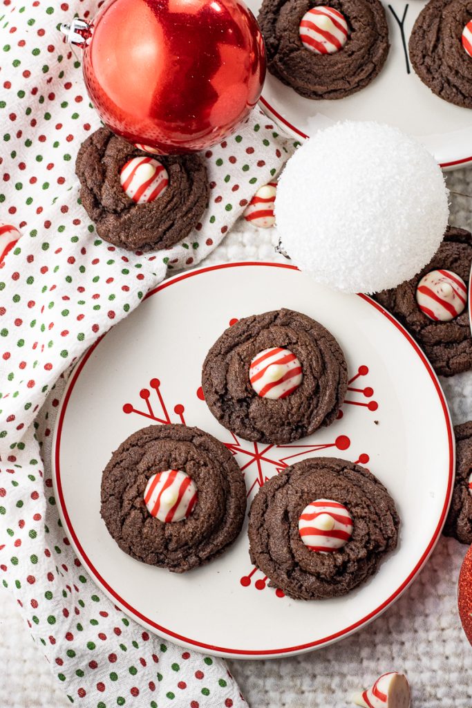 chocolate cookie base topped with a red and white chocolate candy on a white and red plate