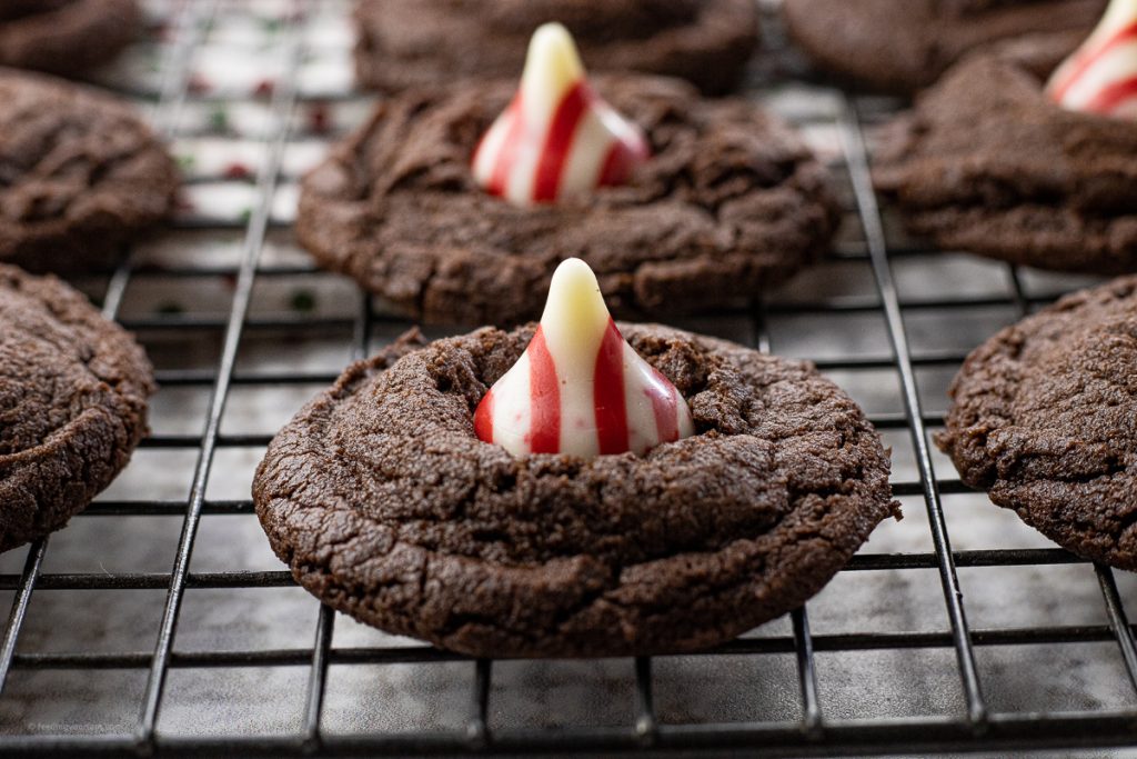 chocolate cookie topped with a white and red candy