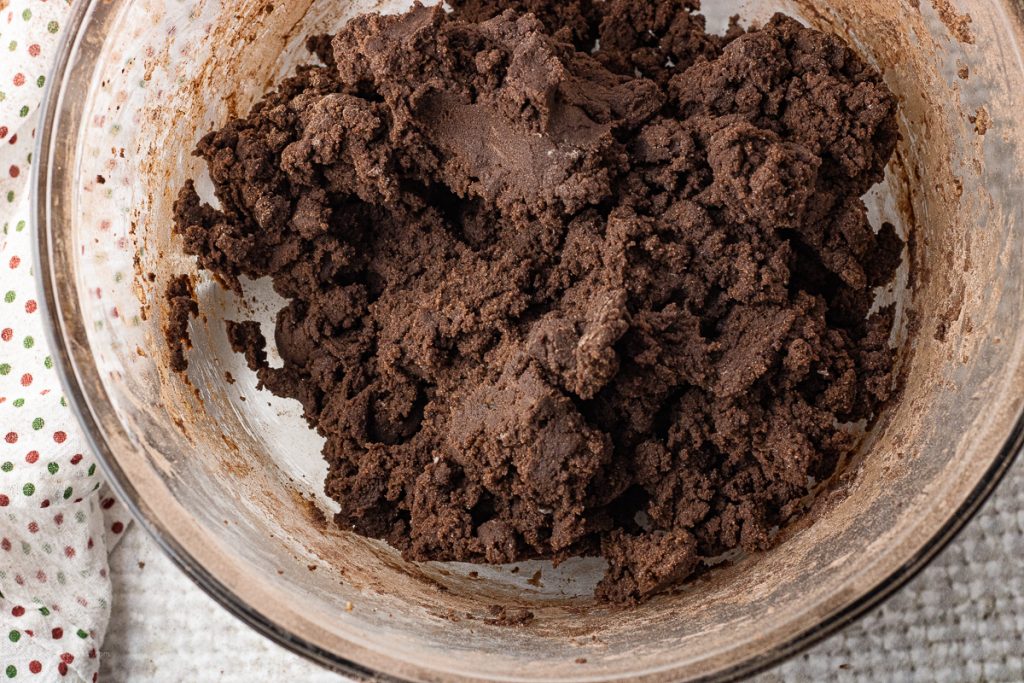 chocolate cookie dough in a glass mixing bowl