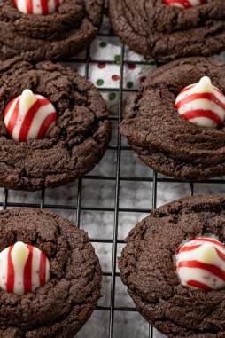 chocolate cookies topped with a red and white chocolate candy