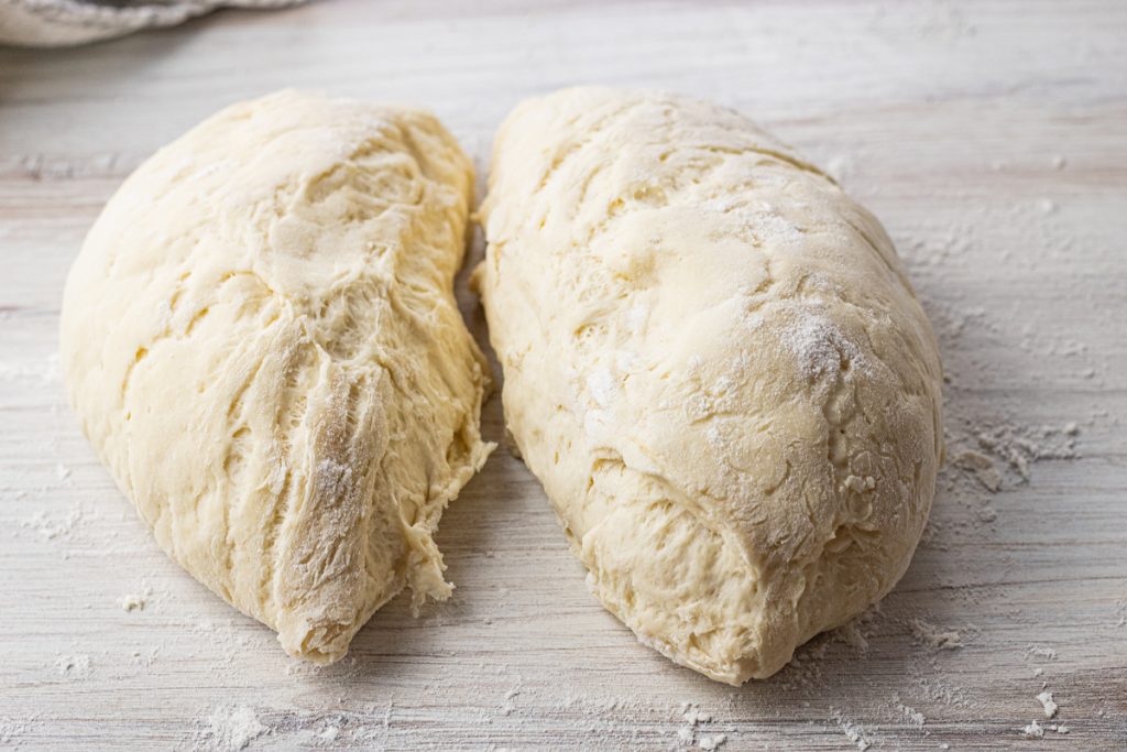 ball of dough sliced into two halves