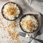 two bowl filled with white rice topped with toasted coconut