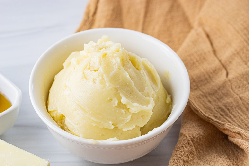 rounded scoop of honey butter in a small white bowl