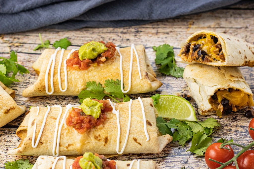 crispy chimichangas topped with salsa, guacamole and sour cream