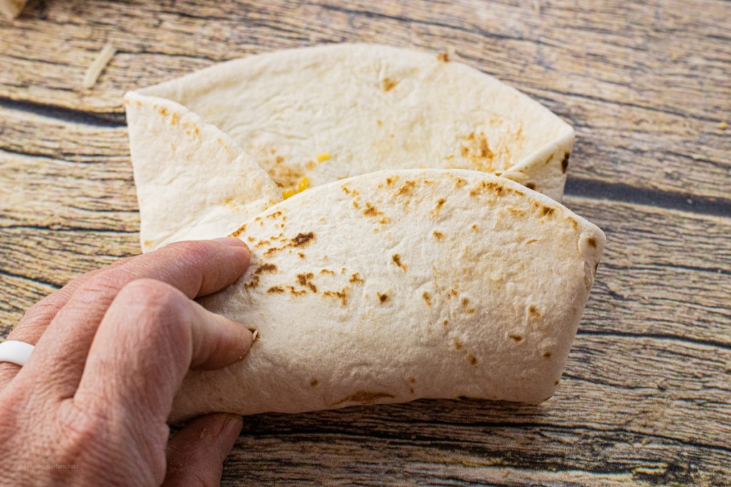 folding a tortilla into a burrito shape