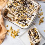 ice cream cake with drizzled chocolate and peanut butter and peanuts