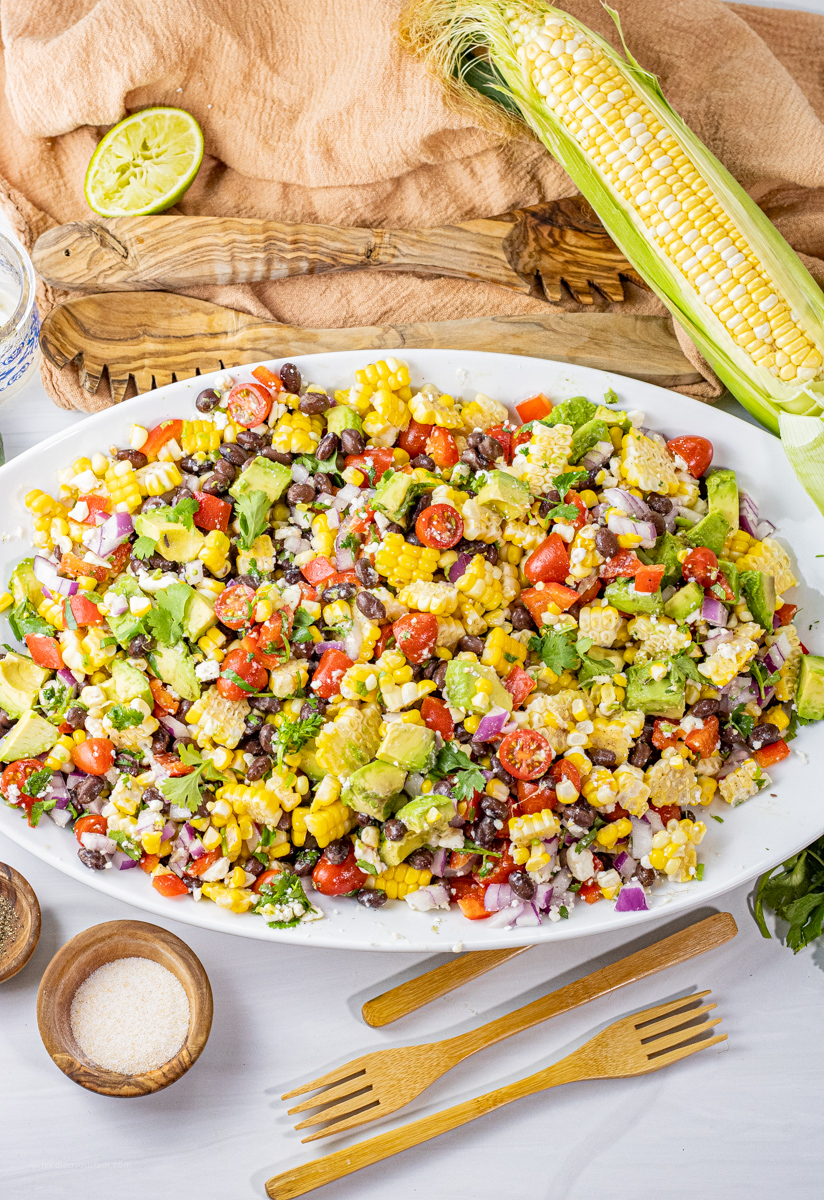 salad with corn and black beans on a white platter