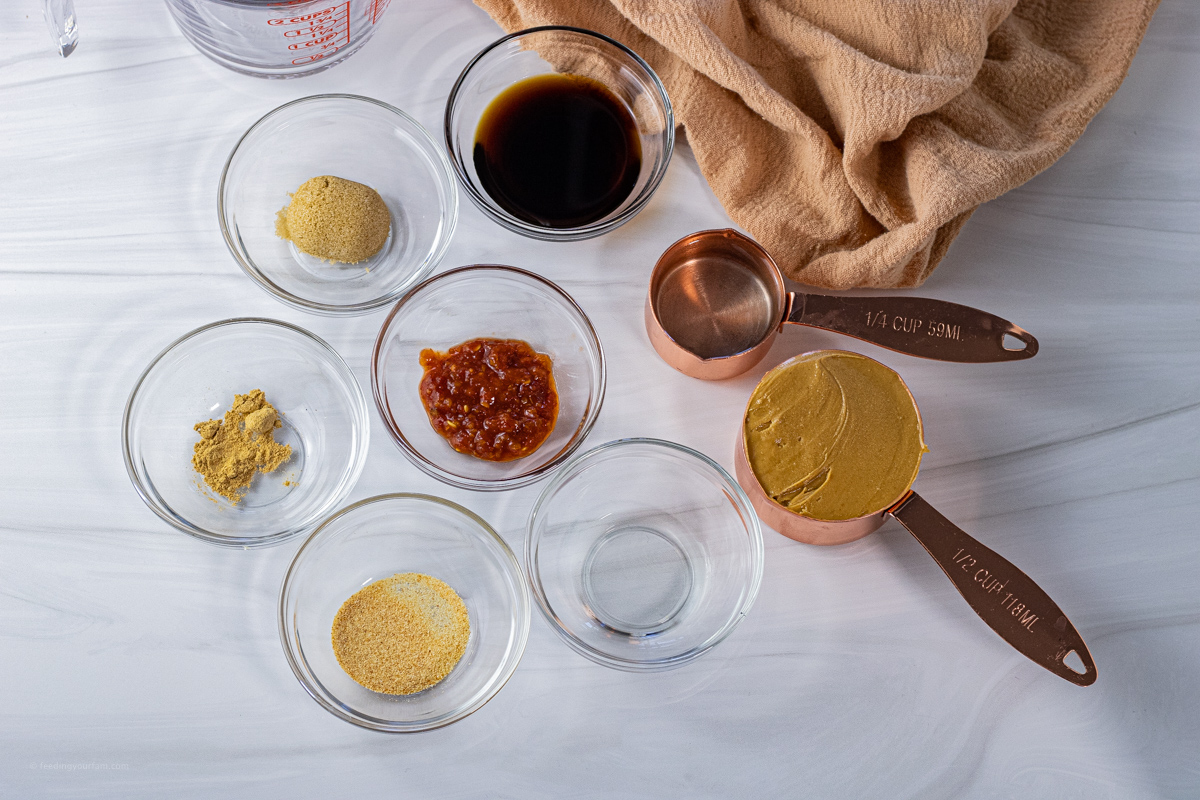 small bowls of ingredients to make a peanut butter sauce