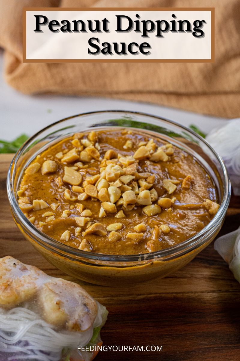 peanut sauce topped with chopped peanuts in a small glass bowl