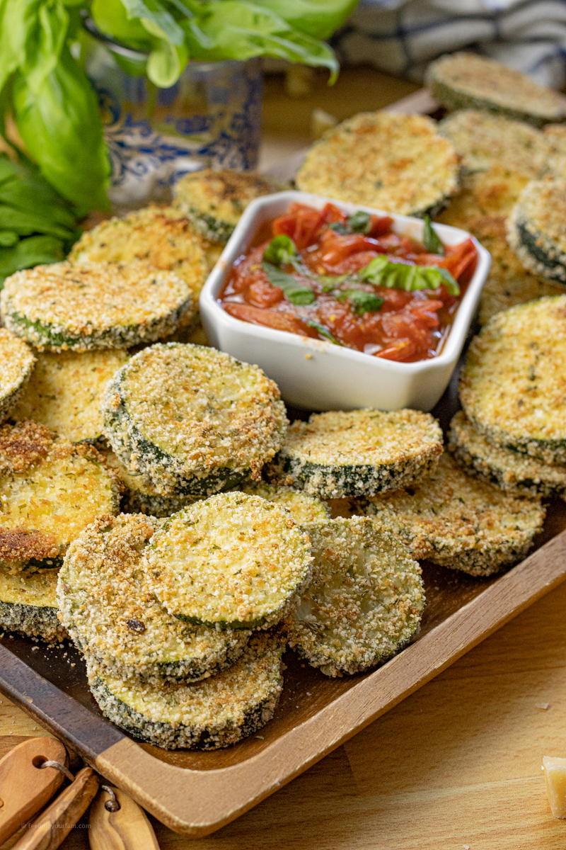 baked zucchini rounds with a tomato dipping sauce in the center