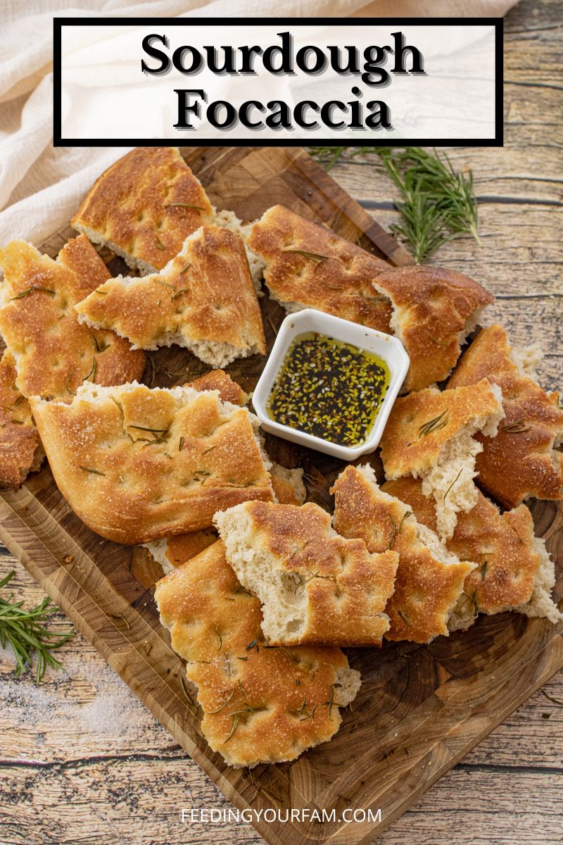 broken up pieces of focaccia bread around olive oil dipping sauce 