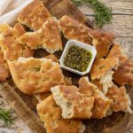 broken up pieces of focaccia with oil dipping sauce