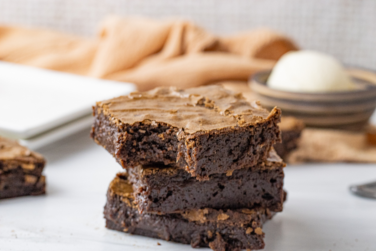 stack of three brownies, one with a bite out of it