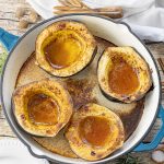 baked acorn squash in a cast iron pan