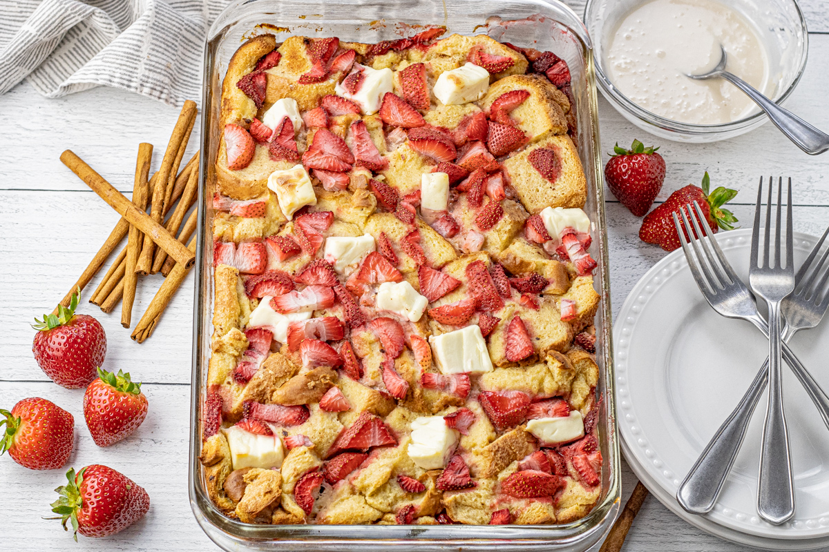 pan of sliced strawberries, cream cheese french toast casserole