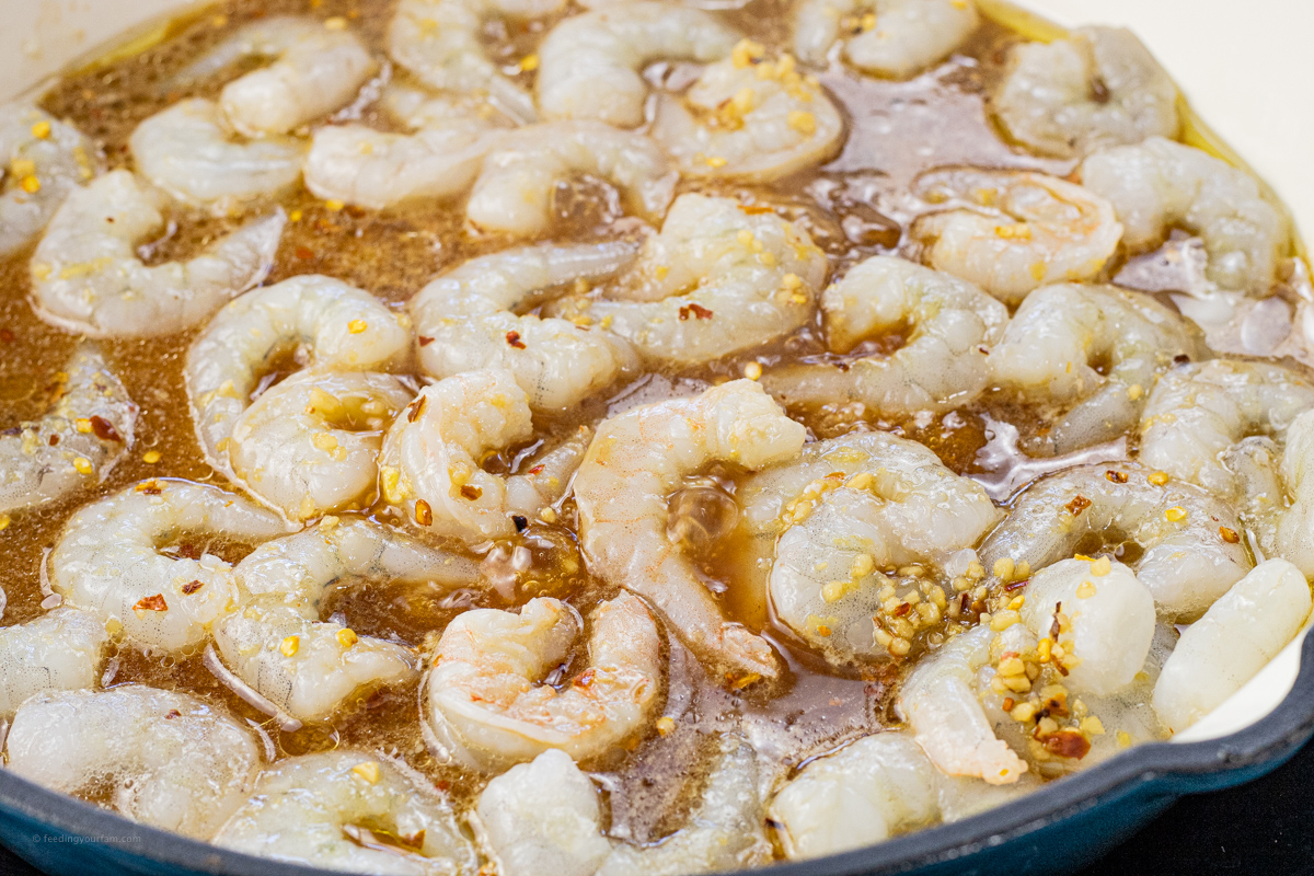 shrimp cooking in a pan with teriyaki sauce
