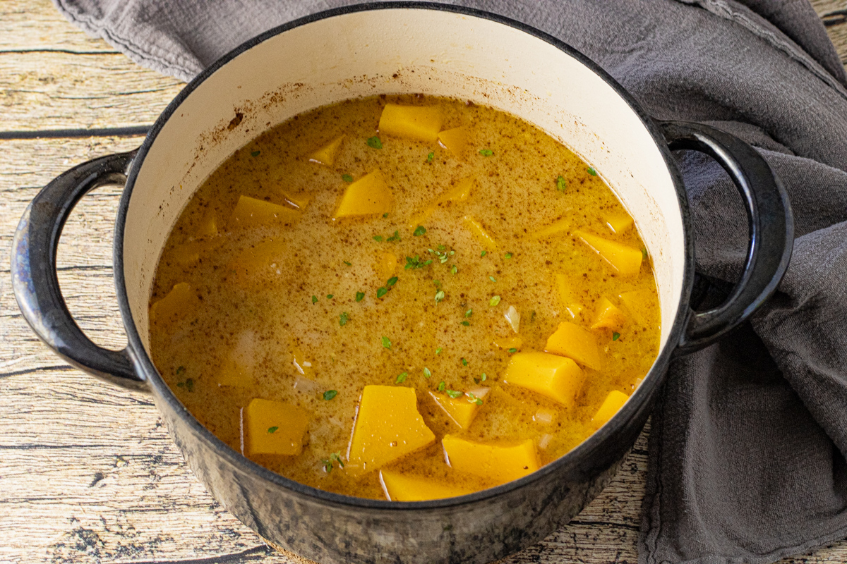 butternut squash in a pot covered with chicken broth