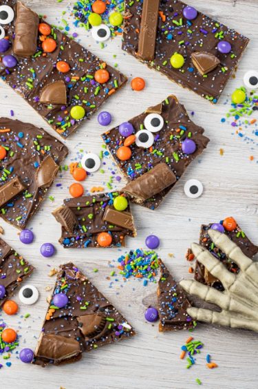 broken pieces of pretzel toffee covered with chocolate, sprinkles and candies