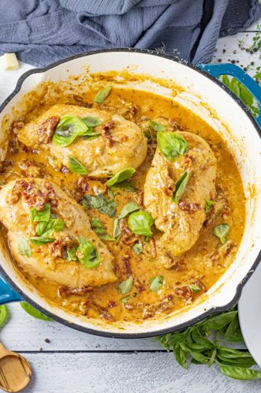 pan with 3 chicken breasts in a creamy tomato sauce