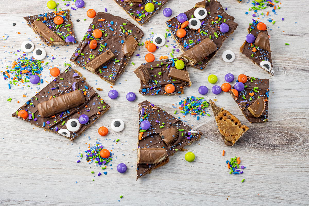 broken pieces of toffee pretzels covered in chocolate and halloween candies