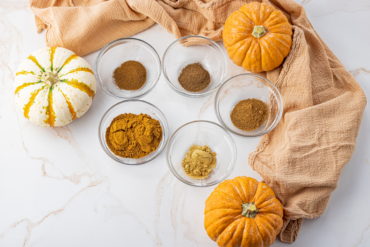 5 small bowls filled with different spices