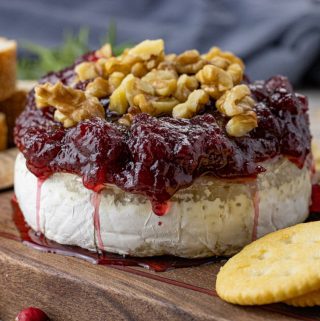 brie topped with cranberry sauce and chopped walnuts