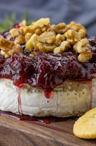 brie topped with cranberry sauce and chopped walnuts