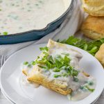 white sauce with peas and tuna over pieces of puff pastry