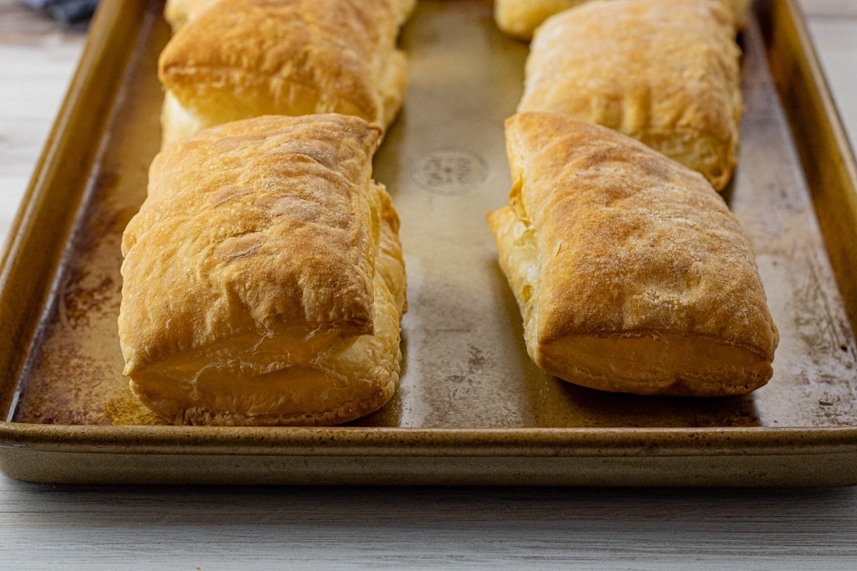puffed up rectangles of puff pastry on a baking pan