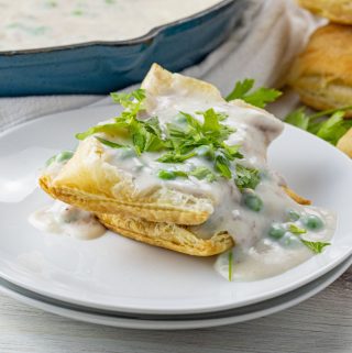 white cream sauce with tuna and peas over puff pastry