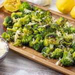 roasted broccoli on a wooden platter