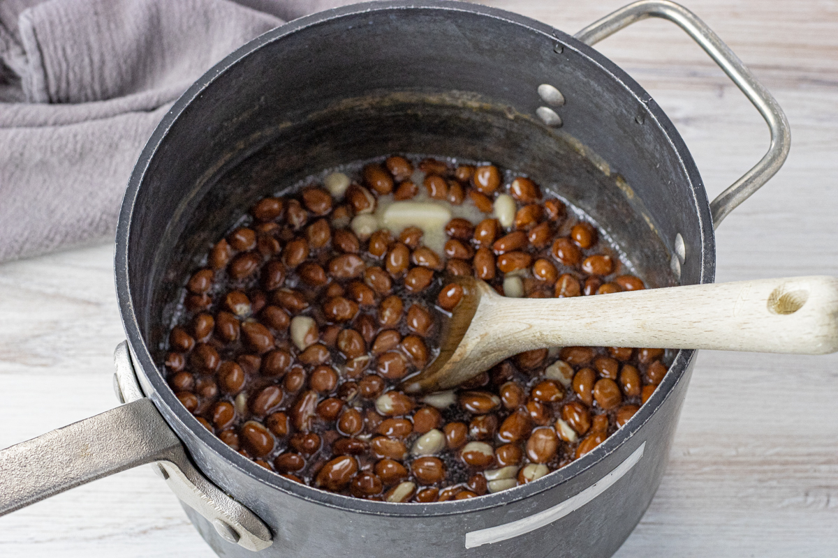 peanuts in a sugar corn syrup mixture in a large pot