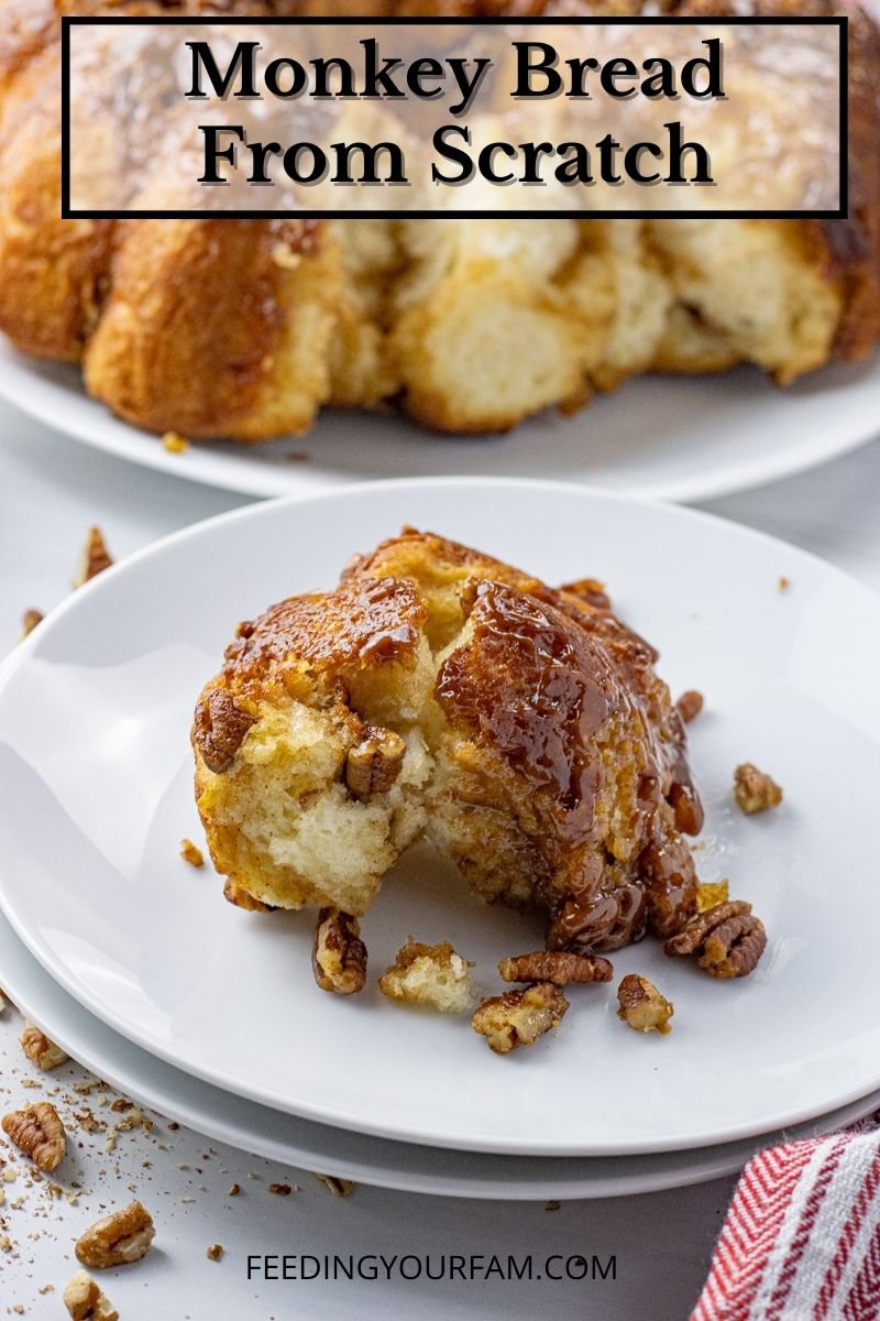 piece of gooey monkey bread with pecans on a white plate