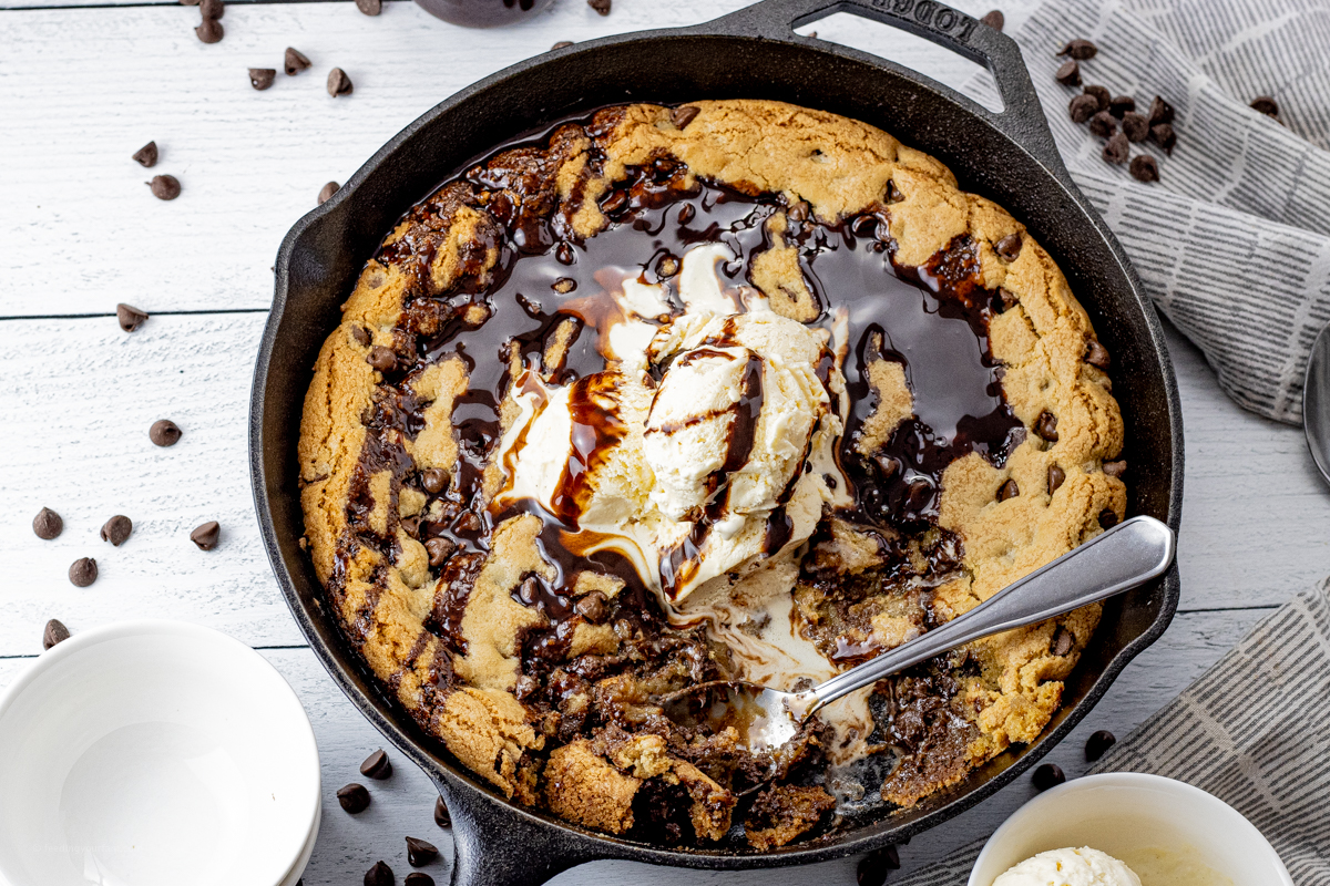 giant skillet chocolate chip cookie topped with ice cream and chocolate sauce