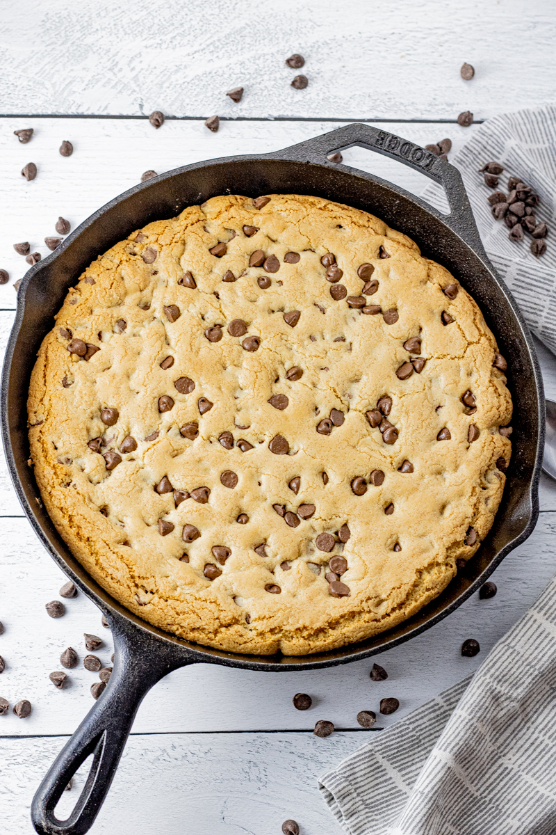 cooked chocolate chip cookie in a cast iron pan