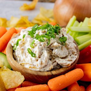 wooden bowl filled with cream cheese onion dip