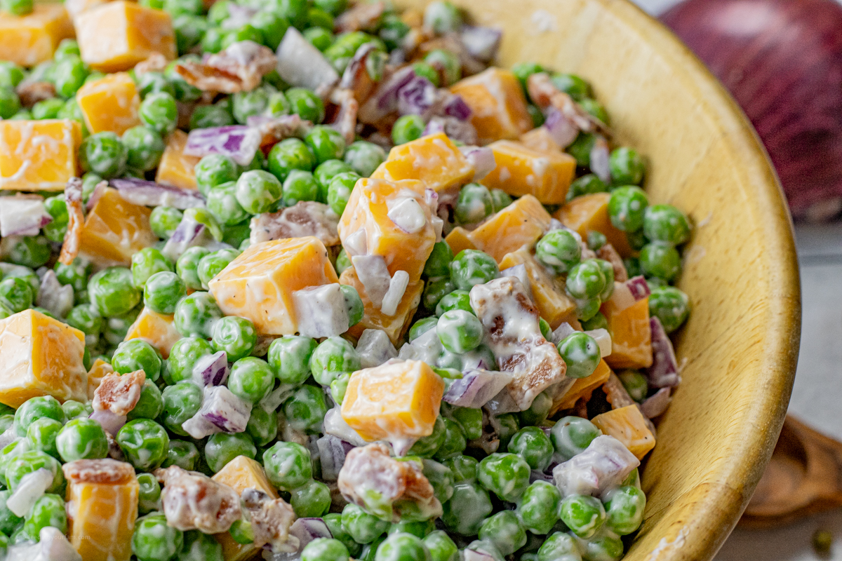 close up picture of green pea salad with a creamy dressing