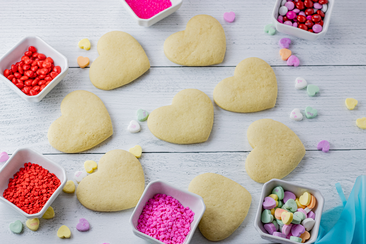 baked heart shaped cookies with valentine's candies around them