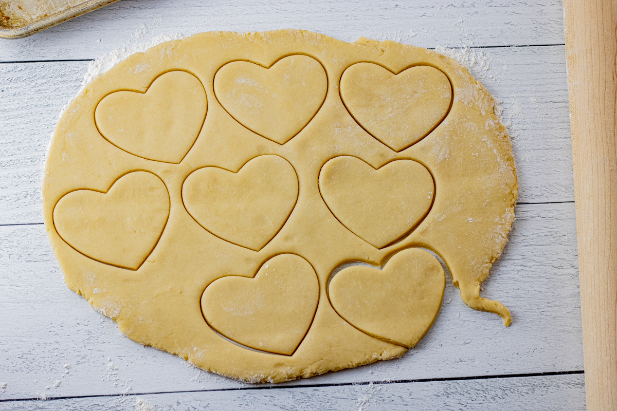 cookie dough rolled out and cut out into heart shapes