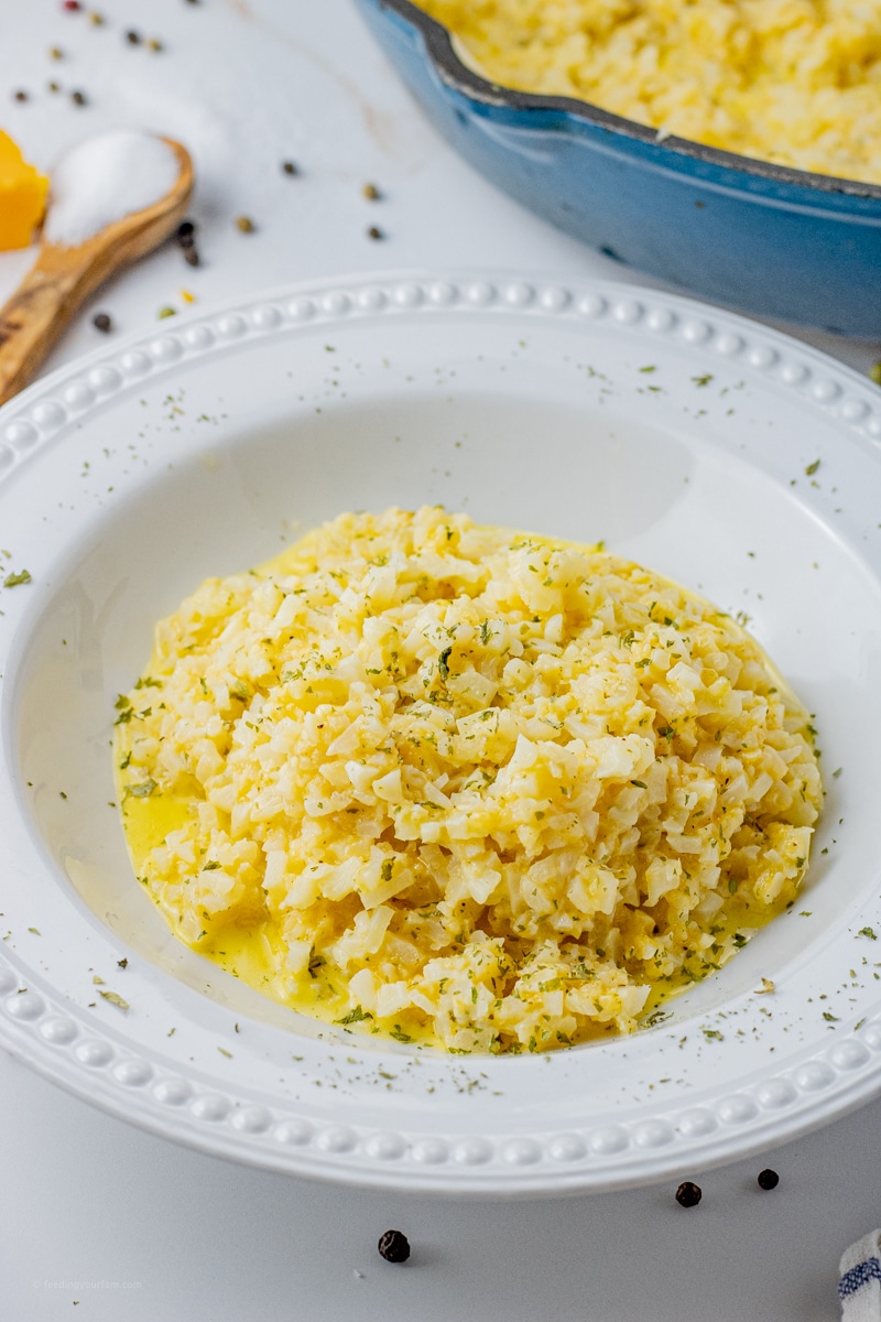 cauliflower rice with cheesy sauce in a white bowl