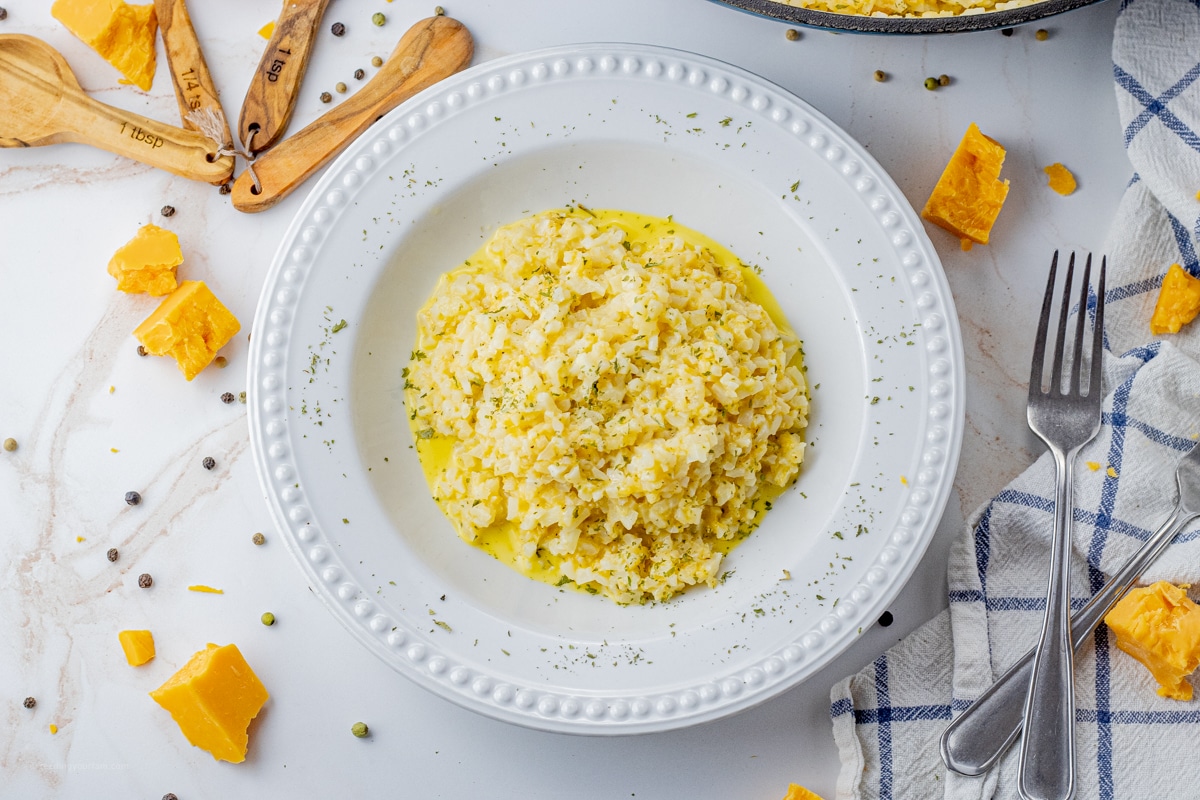 white bowl of cheese and cauliflower rice