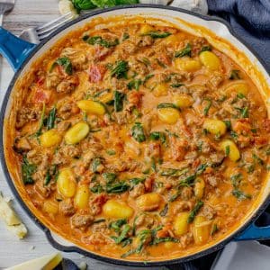 gnocchi in a creamy tomato sauce with spinach, sausage