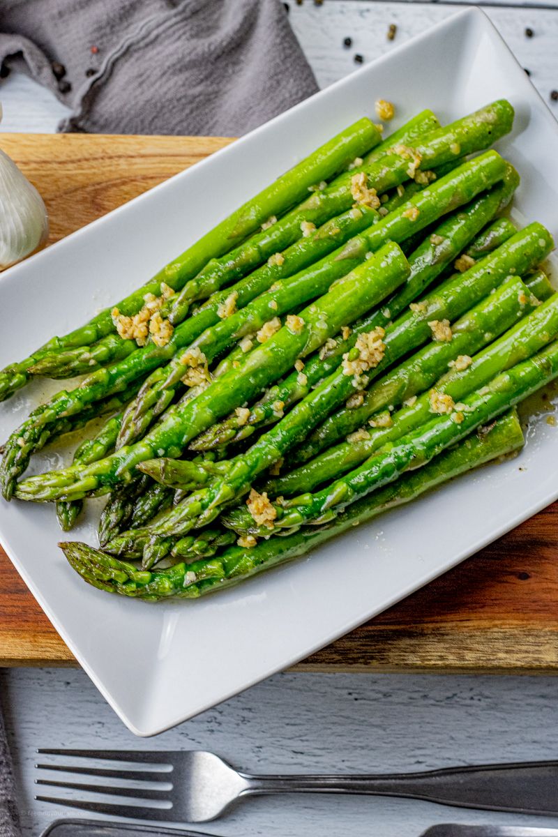Garlic Butter Asparagus is a simple and delicious vegetable side dish. Asparagus is cooked with butter and garlic right on the stovetop to create this flavorful recipe. When asparagus is combined with garlic and butter, it is taken to a whole new level and the best part is, this only takes a few minutes to make.